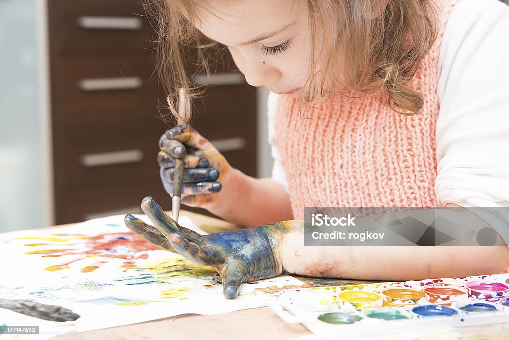 drawing by paints girl drawing paints on paper and hands 12-17 Months Stock Photo