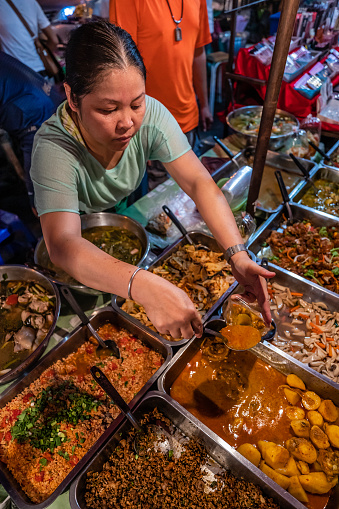 Thai street food seller at the night market in Chiang Mai, Northern Thailand