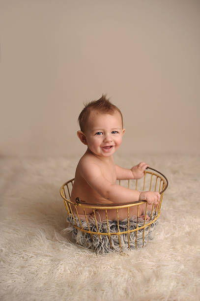istock Smiling Baby Sitting in Antique Egg Basket 177148819