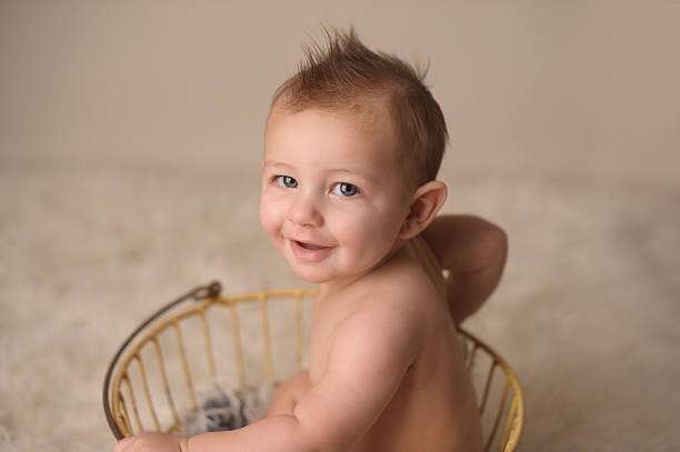 istock Smiling Baby Sitting in Antique Egg Basket 177148844