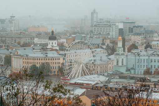 View of the foggy city from Volodymyrska hill park, golden autumn, Kyiv, October 2023