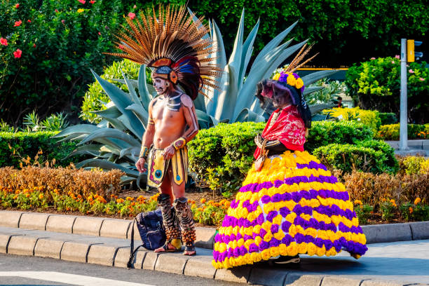 man and woman wearing traditional day of the dead clothing in mexico city Mexico City, Mexico october 31 2023 man and woman wearing traditional day of the dead clothing in mexico city war bonnet stock pictures, royalty-free photos & images