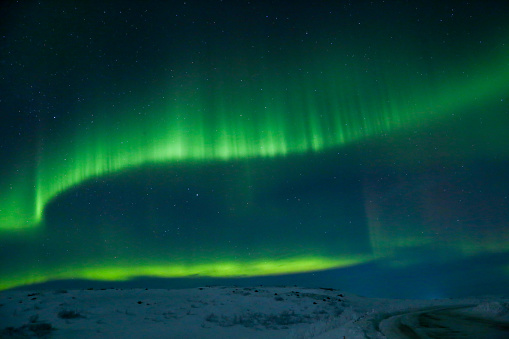 northern lights with green and purple glow in the starry sky, horizontal, scenic