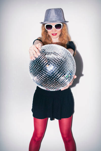 istock Woman with sunglasses holding disco ball 1771557063