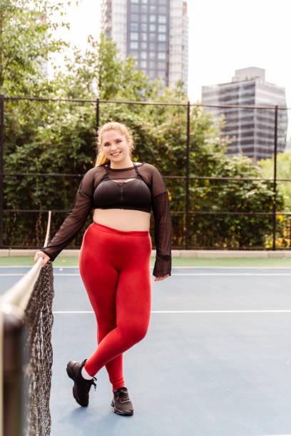 istock Smiling woman with plus size body relaxing after workout session outdoors. Plus size model, motivation, training 1771564704