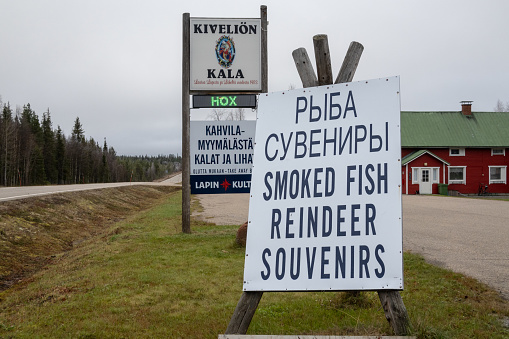 Rovaniemi, Finland  October 6,2023 A large advertisement for smoked fish, reindeer and souvenirs in English and Russian.
