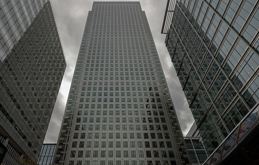 London, England - Oct 16, 2023 - Upward view of Skyscrapers in the business district area of One Canada Square in Canary Wharf. Tall structure architecture in the capital city. Architectural exterior view, Copy space, Selective focus.