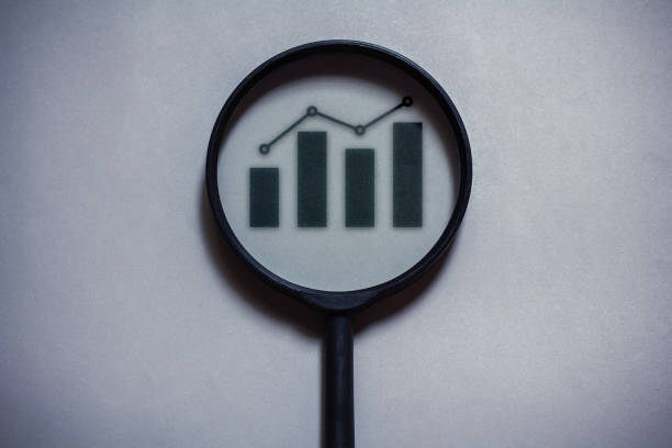 istock magnifying glass on gray background. graph icon in magnifying glass 1771608323