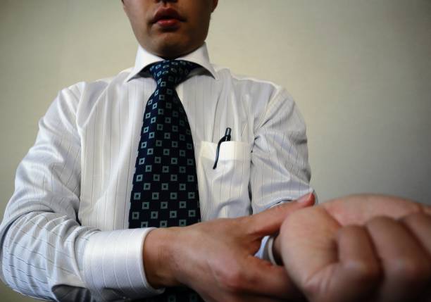 Close-up photo of businessman checking pulse