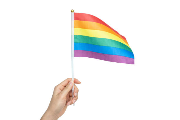 istock Someone hand holding a rainbow flag against white background. 1771641207