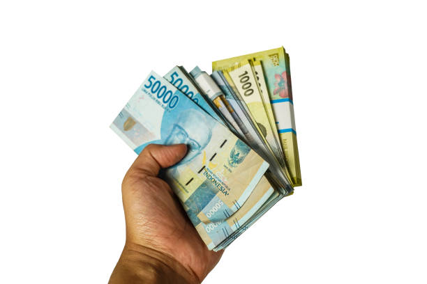 istock male hand holding rupiah banknotes, money white background, isolated 1771660118