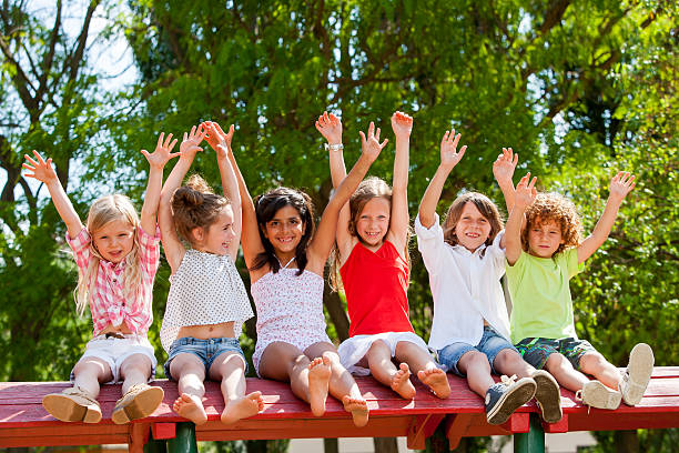 istock Happy kids raising hands outdoors. 177167449