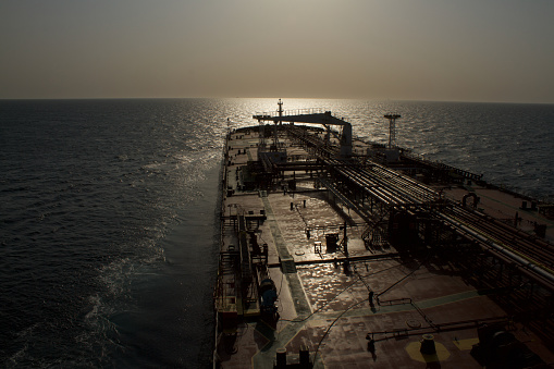Merchant ship carrying crude oil is underway at sea in the morning