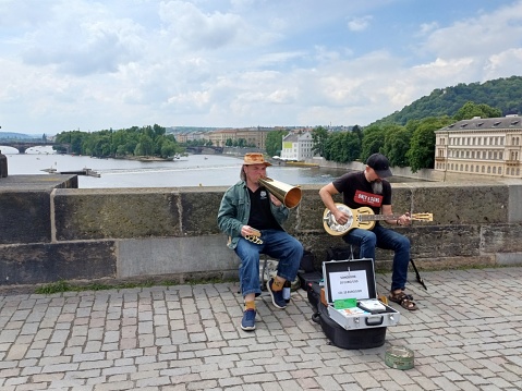 Prague, Czech Republic - June 9, 2023: The band playing guitars and trumpets on the Charles Bridge.
