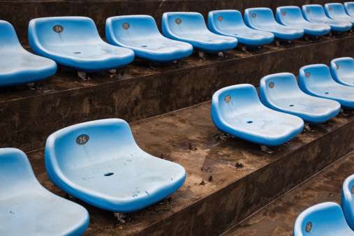 blue rubber seats in a sport stadium in the out door under rain, with wet seats