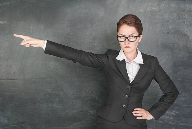 Angry teacher pointing out stock photo