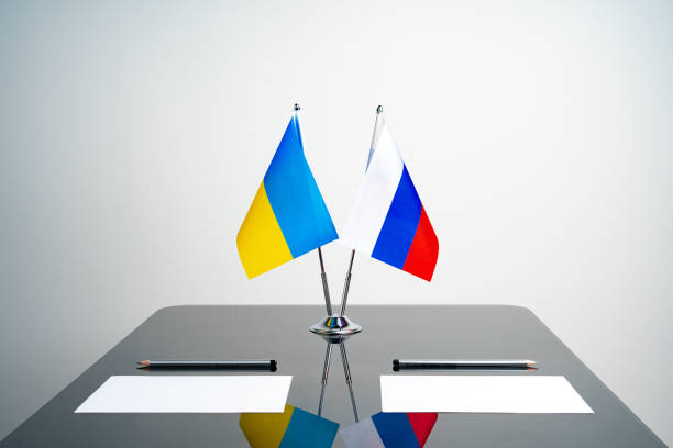 Russia and Ukraine flags on negotiation table Russia and Ukraine flags on negotiation table close up ukraine flag stock pictures, royalty-free photos & images