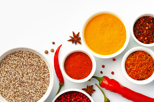 Beautiful composition with various spices on white background close up