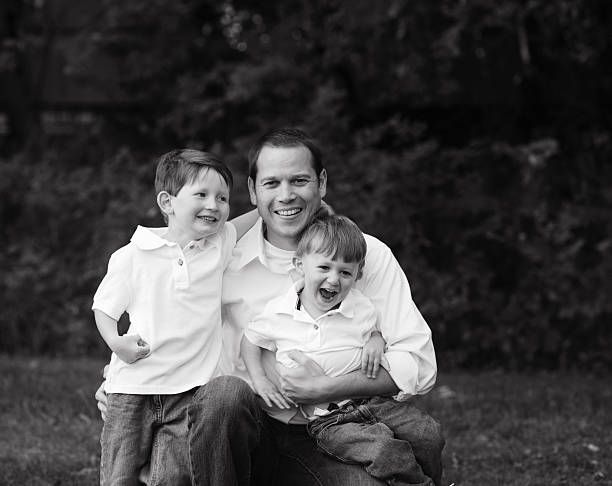 istock Closeup of Father Holding Two Sons 177172452