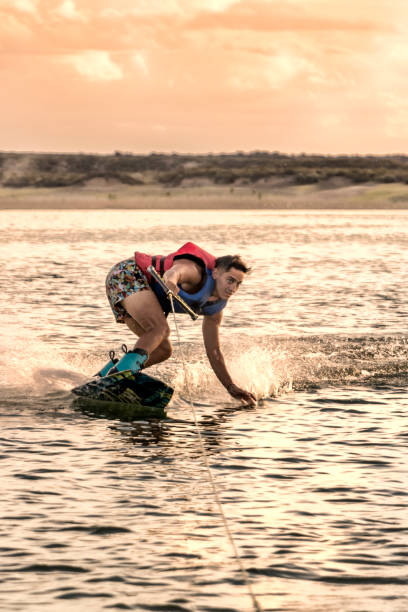 istock Young adult practicing wakeboarding, on lake at sunset. 1771798754