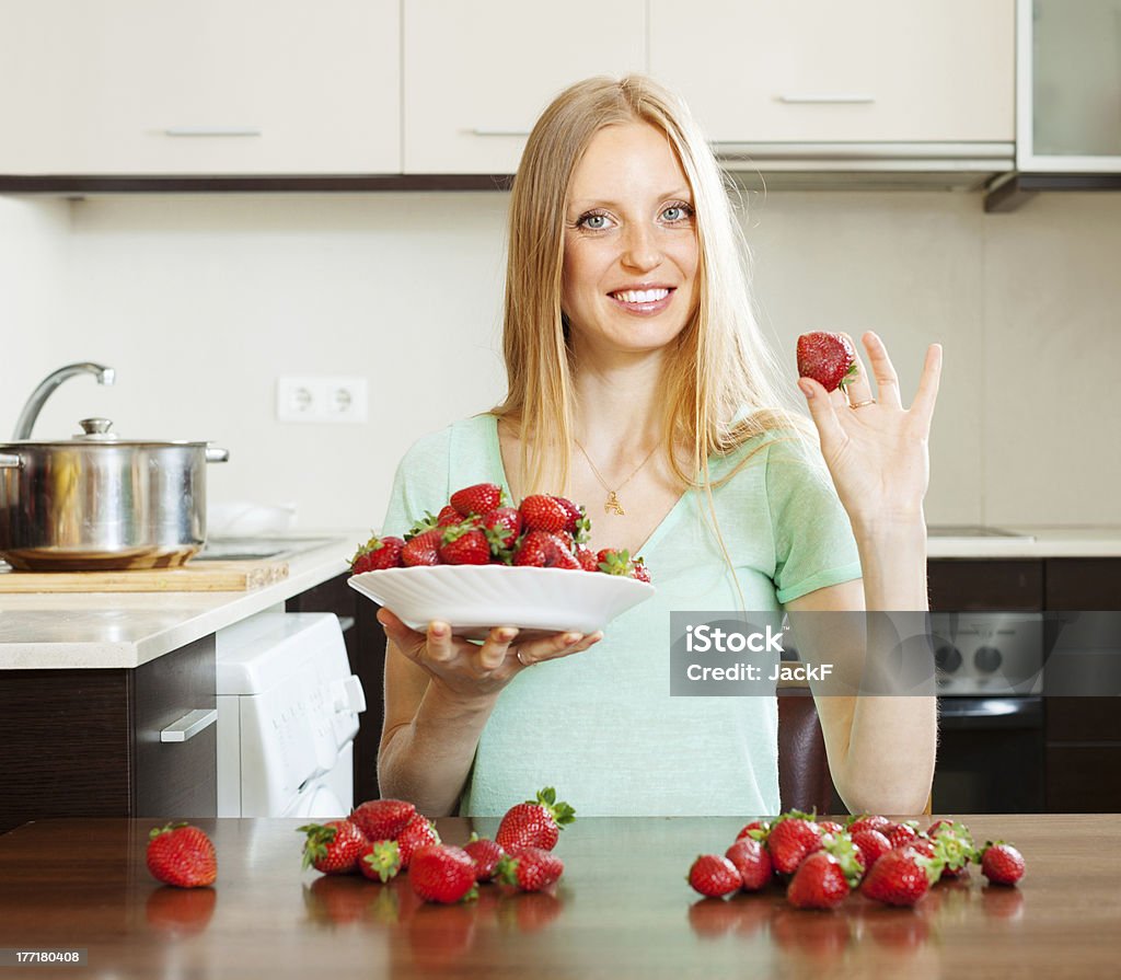 long-haired girl with strawberries blonde long-haired girl with strawberries 25-29 Years Stock Photo