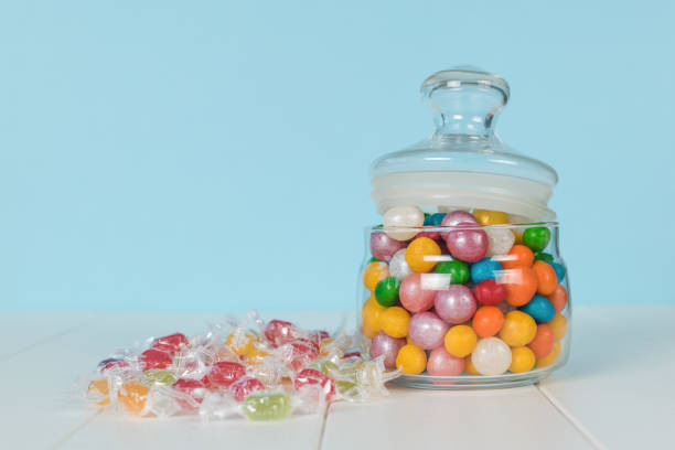 istock Sweets on a white table and in a glass jar. 1771813400