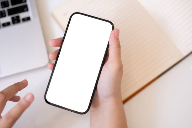 istock A woman using her smartphone at her desk. A white-screen smartphone mockup in a woman's hand. 1771848215