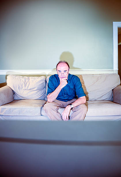 istock Senior man watching television alone at home 177187367