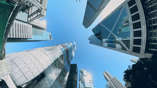 Traveling in Hong Kong's financial center, wide-angle upward view.