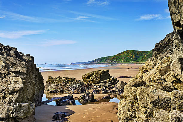 Rocks framing a view of Killantringan Bay stock photo