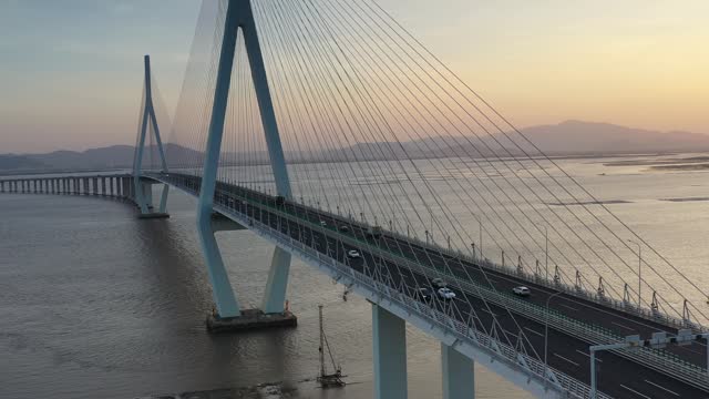 Traffic flow on cable-stayed bridge at twilight
