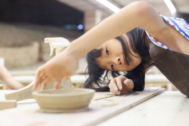 istock A girl is kneading clay in the pottery classroom 1771940468
