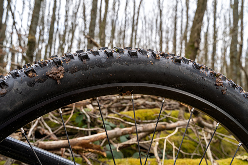 Dirty electric mountain bike wheel in the forest