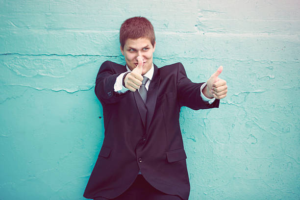 istock Young businessman making a face in front of dirty wall 177197654