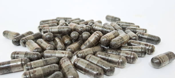 istock Black cumin capsules or commonly called (Habbatussauda) are isolated on a black background. Nigella sativa 1771979824