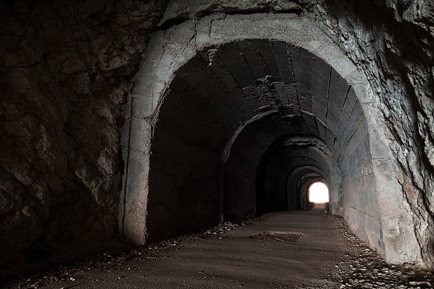 istock Dark abandoned tunnel interior perspective with glowing end 177201129