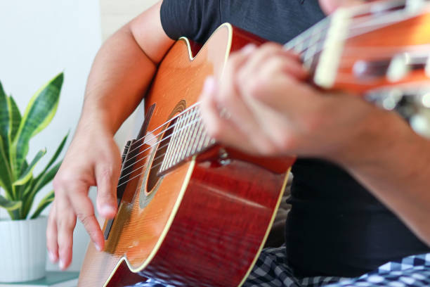 istock Close-up of a man playing guitar at home. 1772013464