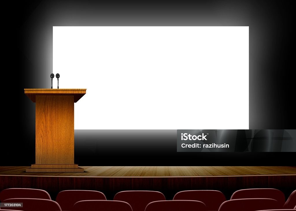 Bright presentation board behind podium in a conference hall Conference hall with podium and blank presentation  screens  Lectern Stock Photo