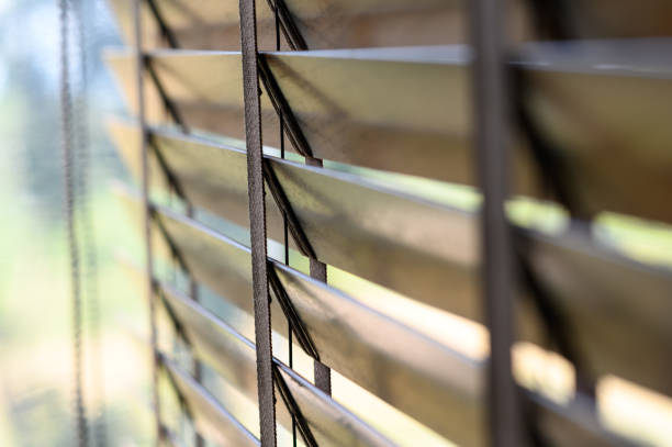 istock Close-up brown wooden blinds. lighting range control sunlight coming from a window. decoration interior. Modern jalousie. 1772041077