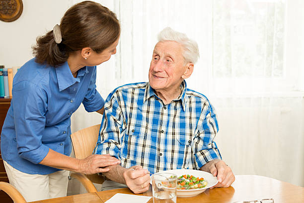 istock Carer giving senior man lunch 177204981