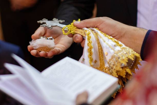 istock hands in gold lace and white shawl with open bible 1772054866
