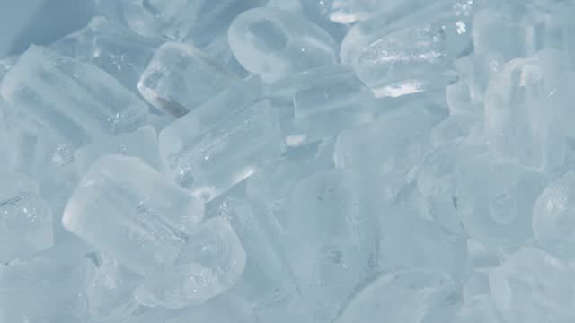 Close up and handheld Footage of Hand scooping fresh cool ice tube background and texture.