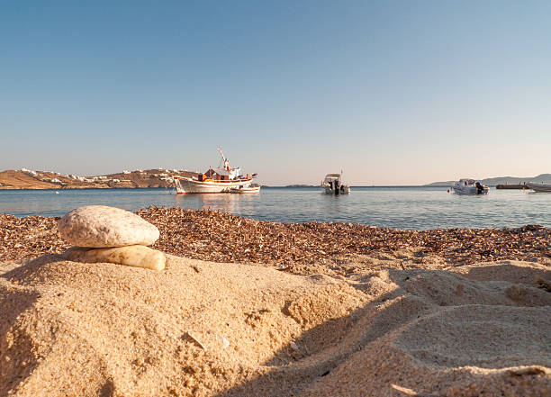 pebbles on the sandy beach, boat to the endless Aegean