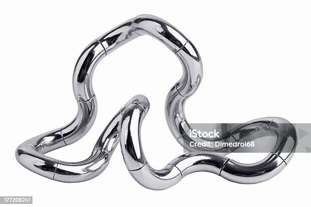 Metal Puzzle In The Form Of A Curve Stock Photo - Download Image Now - Puzzle, Tangled, Confusion