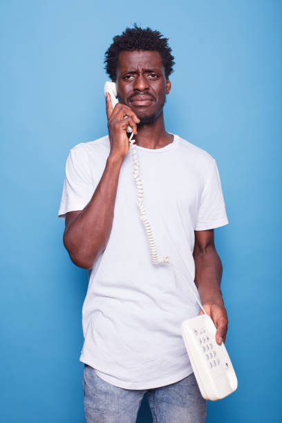 istock Black man speaking on landline phone 1772084466