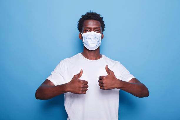 istock Black man with mask doing thumbs up 1772084983