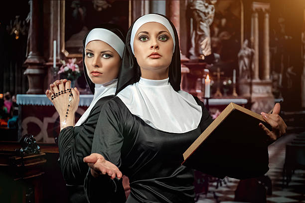 Nuns Two attractive young nuns with rosary and bible praying in the c nun catholicism sister praying stock pictures, royalty-free photos & images