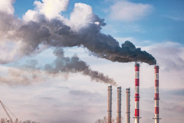 istock Industrial red and white tall chimneys exhausting black smoke 1772092927