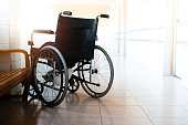 Single wheelchair parked in hospital hallway