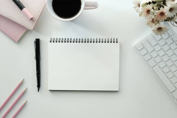 istock White office desk table with blank notebook, computer keyboard and other office supplies. Top view with copy space, flat lay. 1772110210